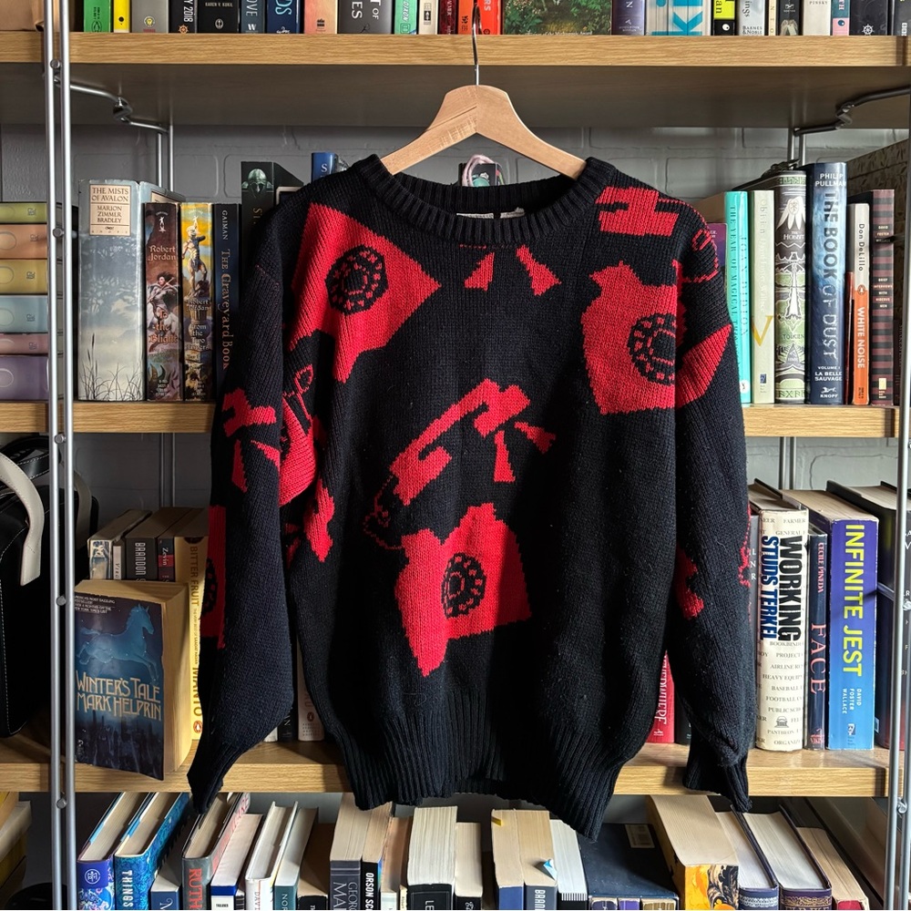 Black and red vintage sweater with unique print design featuring telephones